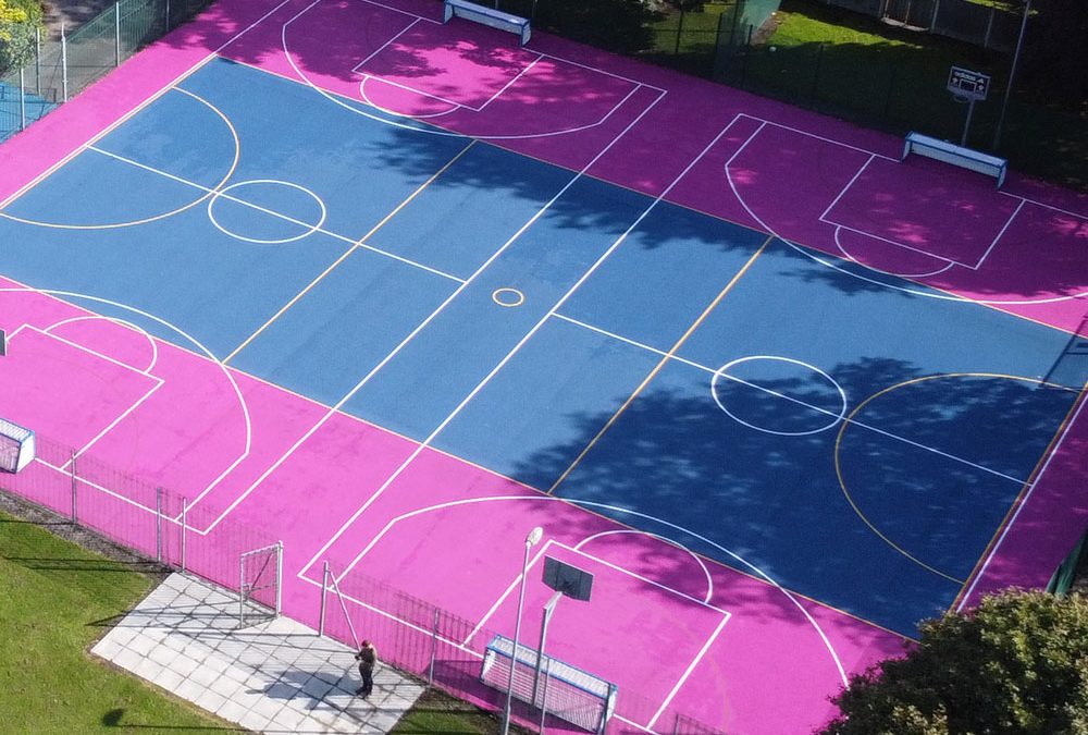 School Sports multi-use games area MUGA pink-blue Aerial view of multi-use games area installed by MAC Groundwork