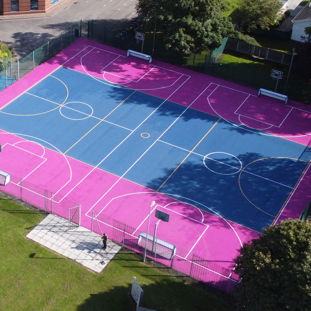 School Sports multi-use games area MUGA pink-blue Civils and groundworks, finishing concrete foundations for commercial site at Bet365 Stadium, Stoke-on-Trent.