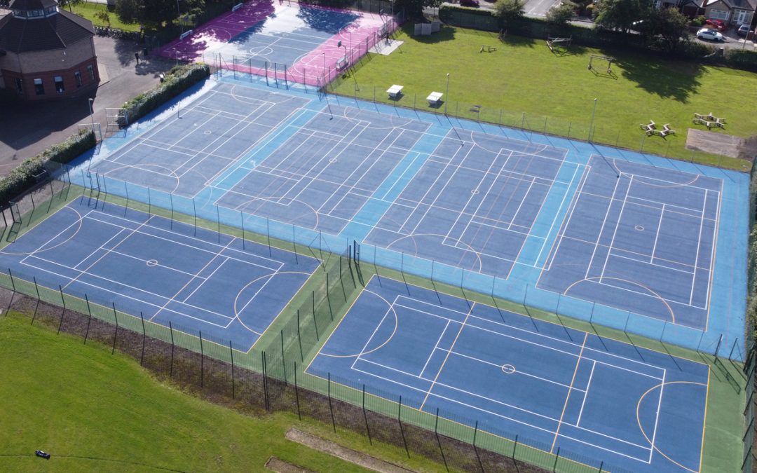 Sports-pitch-MUGA-leisure-Installation-contractors Aerial view of outdoor multi-use sports courts resurfaced and repaired at Chesterfield High School, Liverpool.