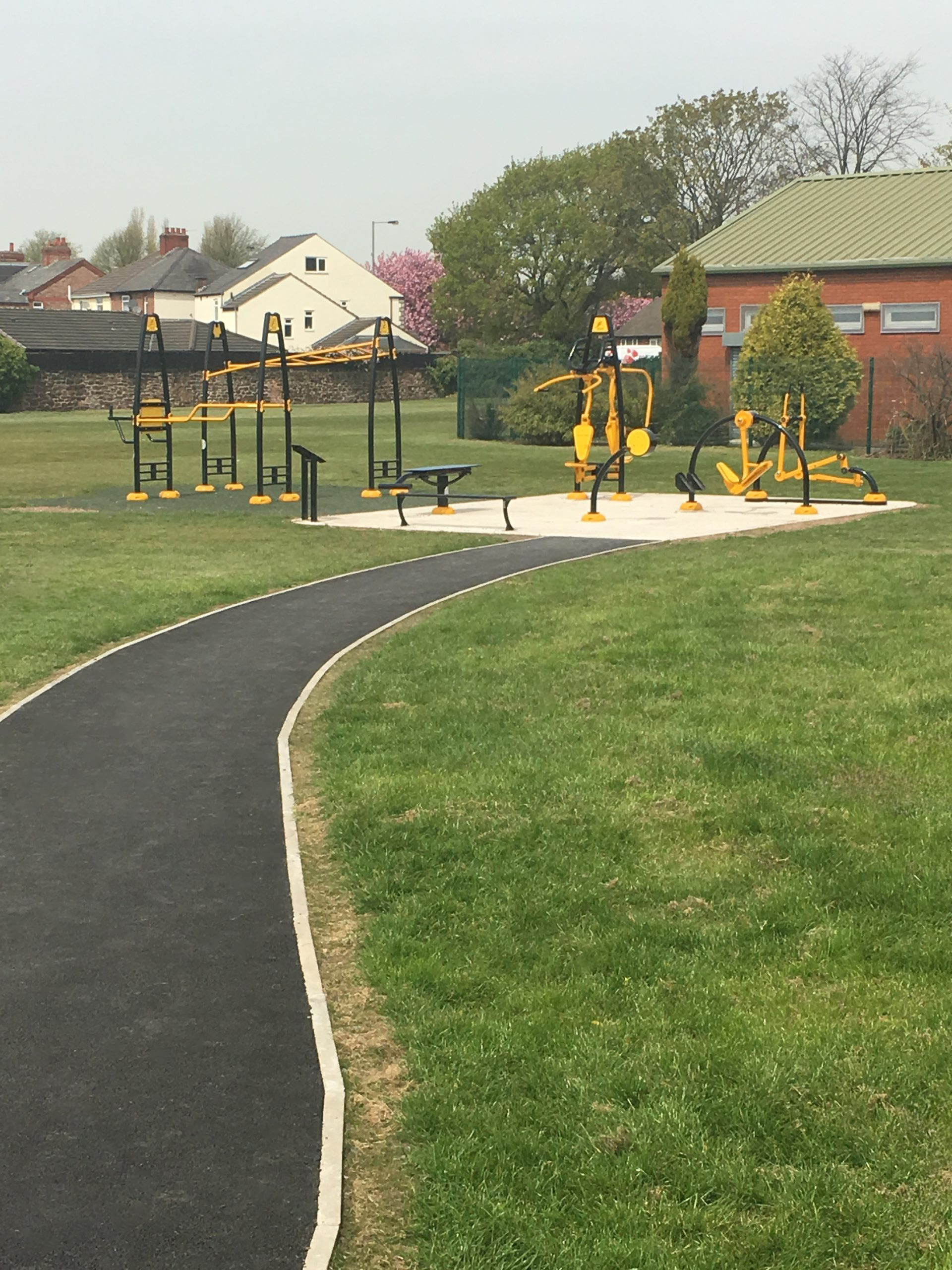Pathway - public footpath to outdoor gym installation with yellow and green bars for circuit training.